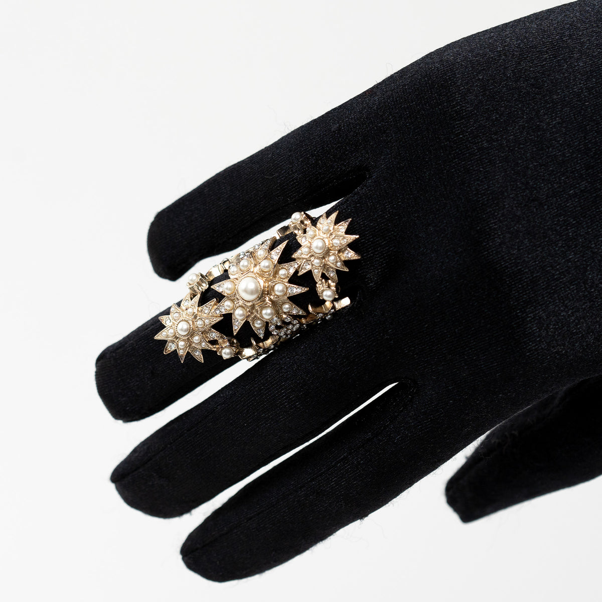 Pre-Loved Chanel™ Gold Tone Faux Pearl and Crystal Embellished Multi Star Ring on hand