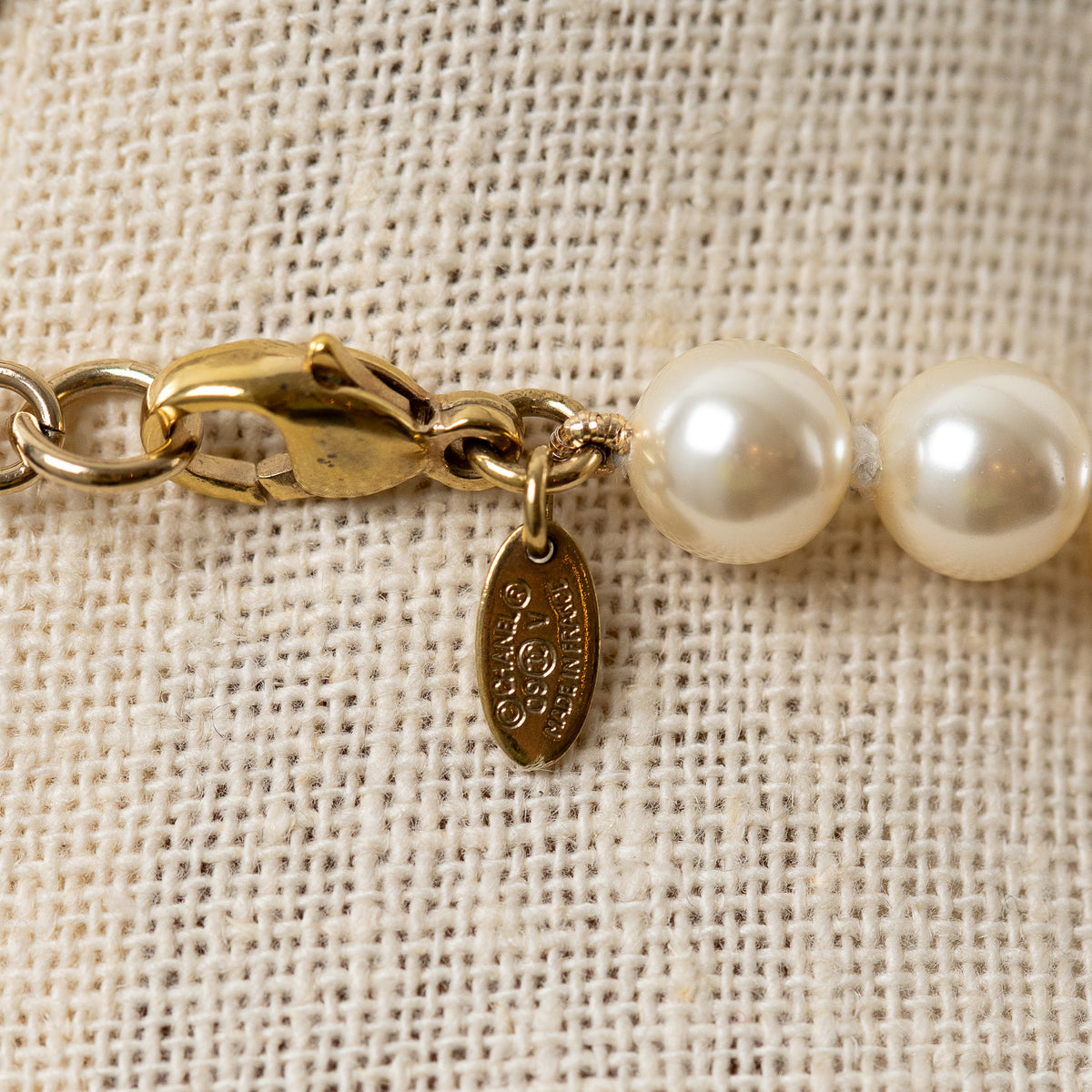 Pre-Loved Chanel™ Faux Pearl Necklace with Gold Tone Logo Links Embellished with Pearls