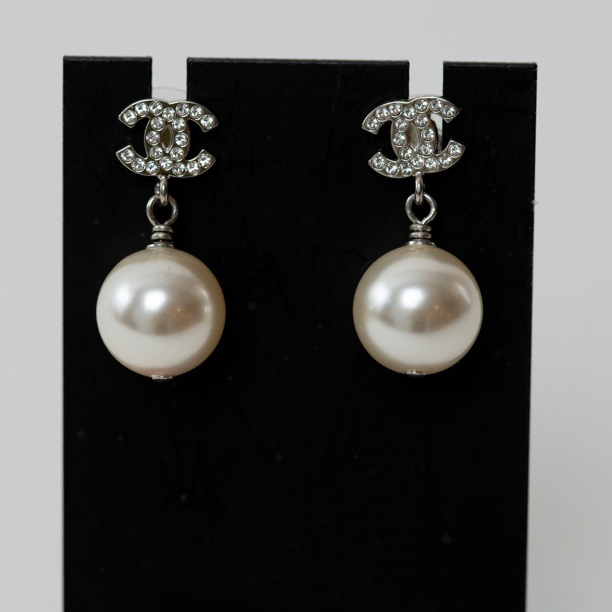 Pre-Loved Chanel™ Silver Tone Mini Crystal Embellished Logo Faux Pearl Drop Earrings