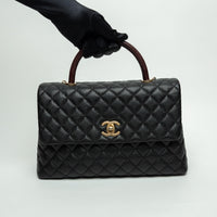Pre-Loved Chanel™ Black Pebbled Leather Medium Coco Handle Bag with Burgundy Lizard Leather Handle