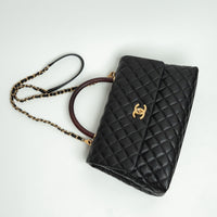 Pre-Loved Chanel™ Black Pebbled Leather Medium Coco Handle Bag with Burgundy Lizard Leather Handle