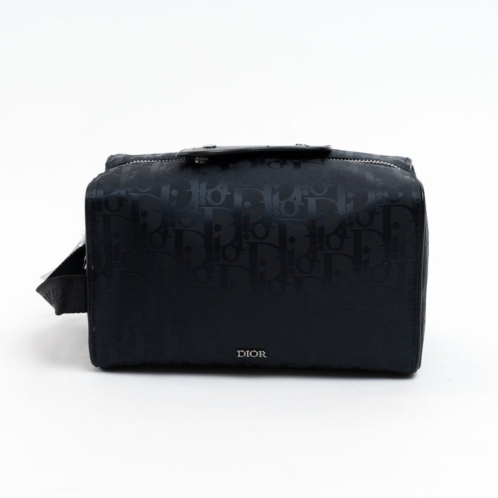 Black Dior bag with logo pattern on a white background