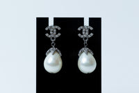silver tone logo earrings with tear drop pearls (close up)