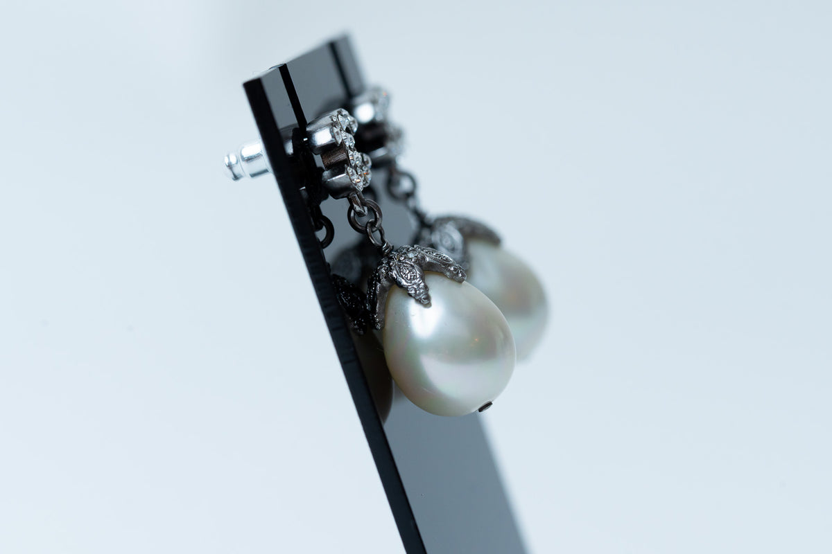 silver tone logo earrings with tear drop pearls (side)