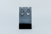silver tone star drop earrings with crystal embellished logo (front)