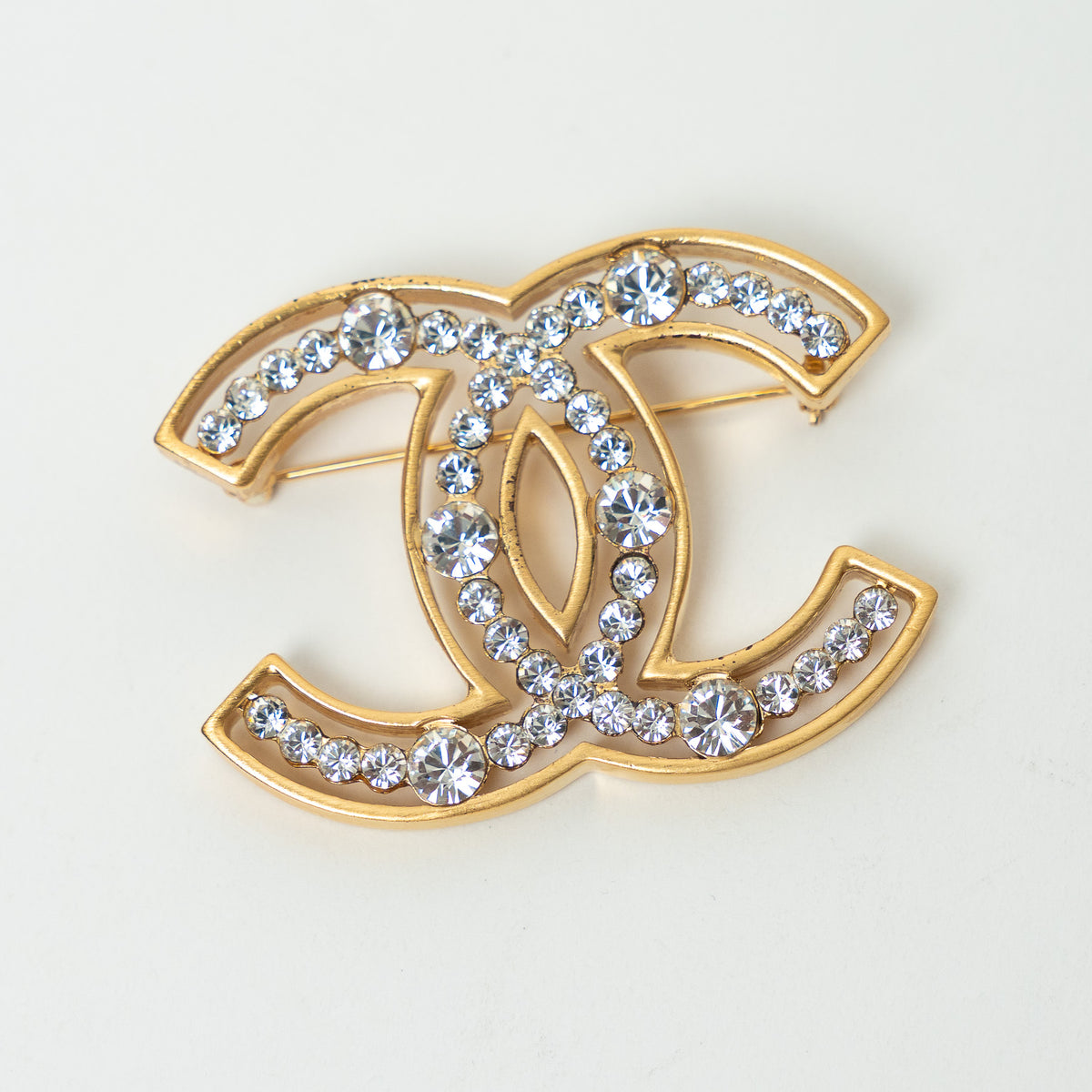 Pre-Loved Chanel™ Gold Tone Crystal Embellished Cut Out Logo Brooch