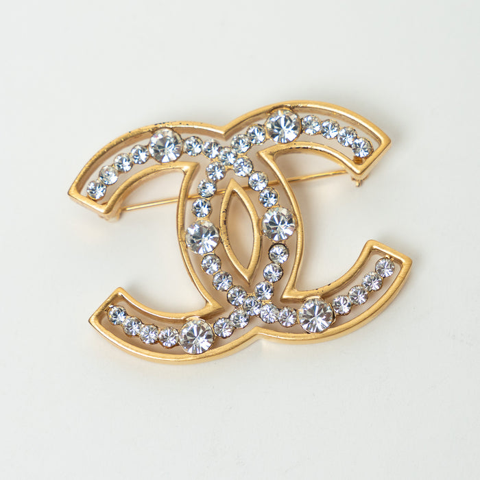Pre-Loved Chanel™ Gold Tone Crystal Embellished Cut Out Logo Brooch