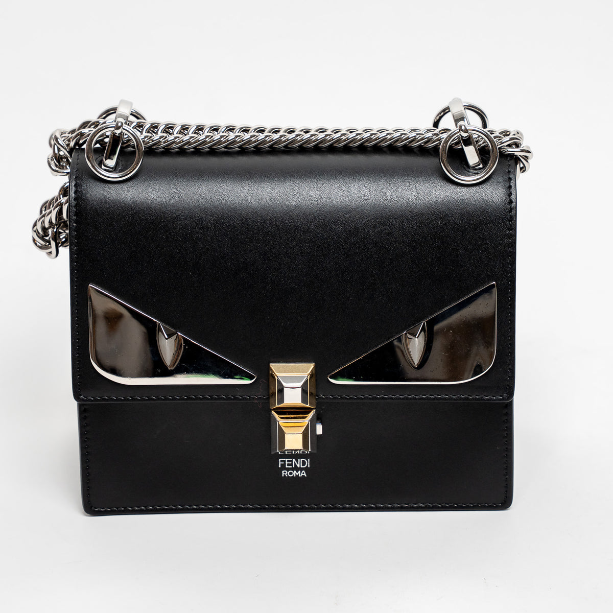 Black Fendi handbag with chain strap on a white background