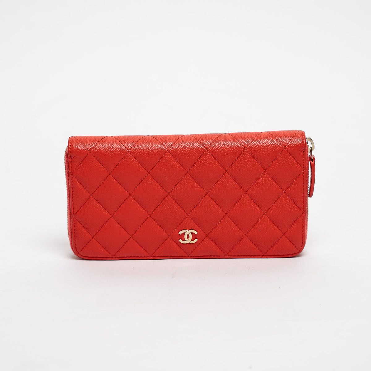 Red quilted handbag with gold CC logo on a white background
