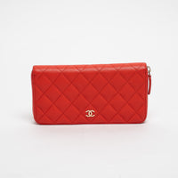 Red quilted handbag with gold CC logo on a white background