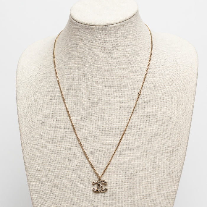 Pre-Loved Chanel™ Gold Tone Logo Pendant Necklace Inset with Clear and Black Crystals