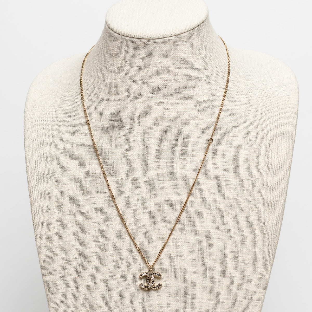 Pre-Loved Chanel™ Gold Tone Logo Pendant Necklace Inset with Clear and Black Crystals