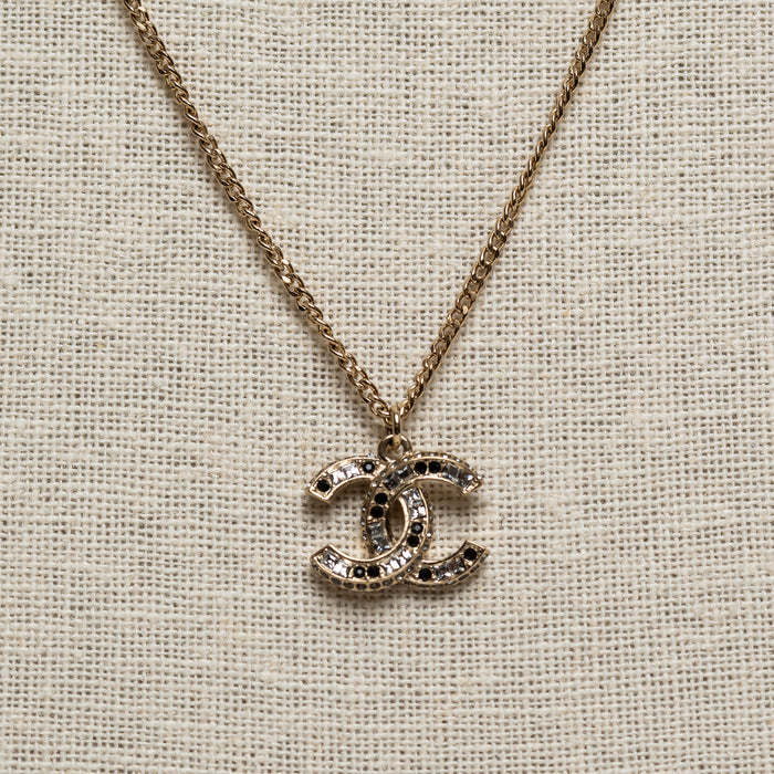 Pre-Loved Chanel™ Gold Tone Logo Pendant Necklace Inset with Clear and Black Crystals
