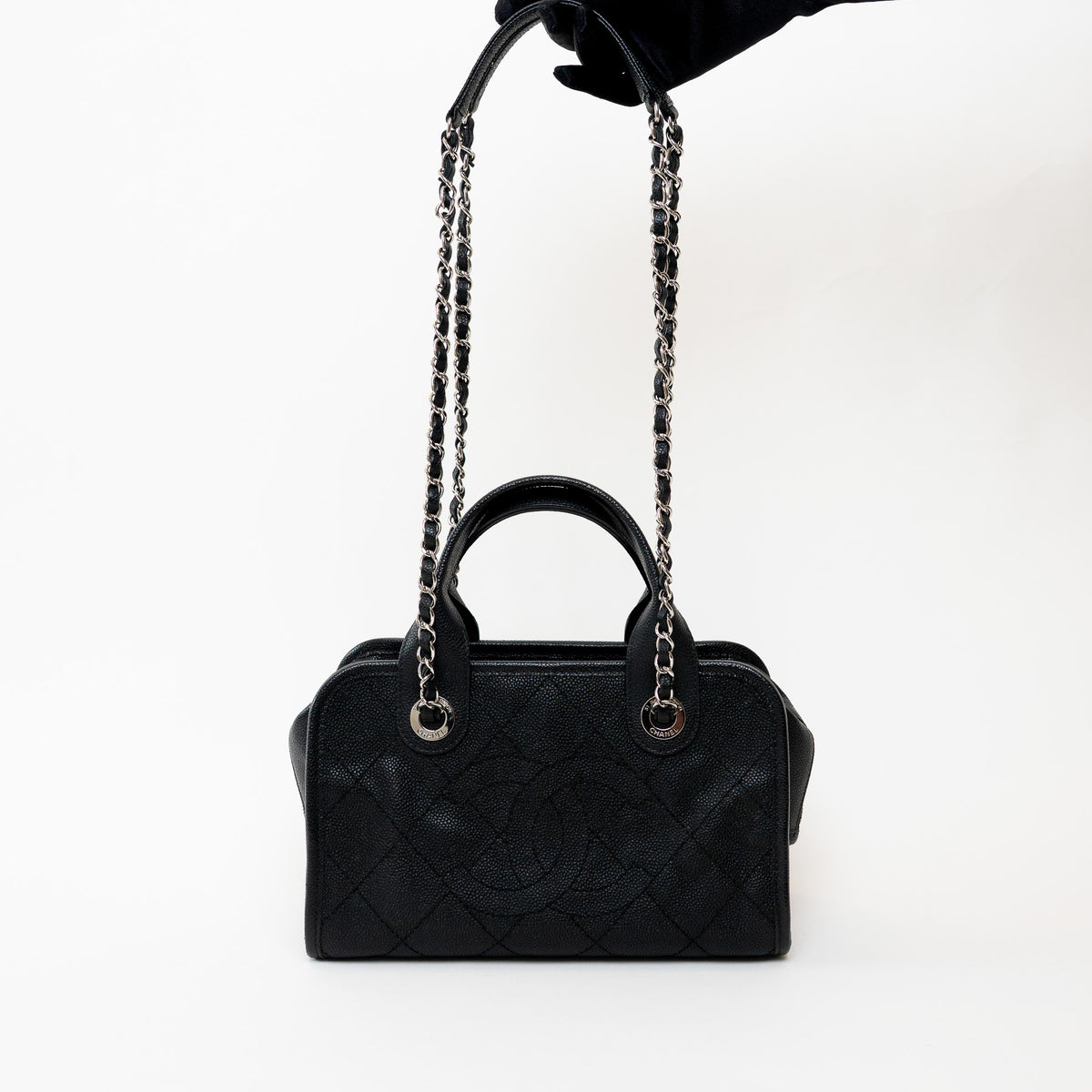 Pre-Loved Chanel™ Black Pebbled Leather Bowling Bag held in hand