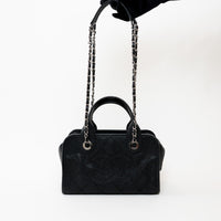 Pre-Loved Chanel™ Black Pebbled Leather Bowling Bag held in hand