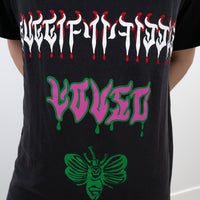 Black t-shirt with colorful text and graphics on a white background