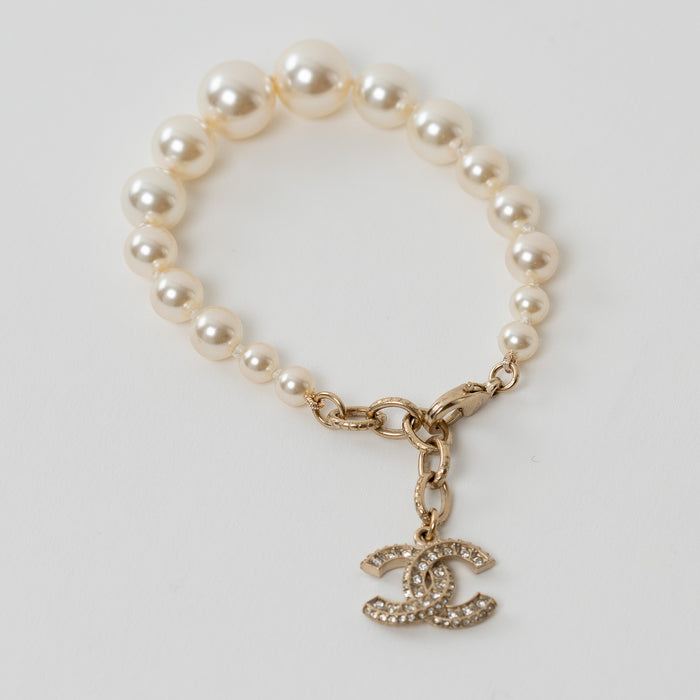 Pre-Loved Chanel™ Gold Tone and Faux Pearl Bracelet with Crystal Embellished Gold Logo