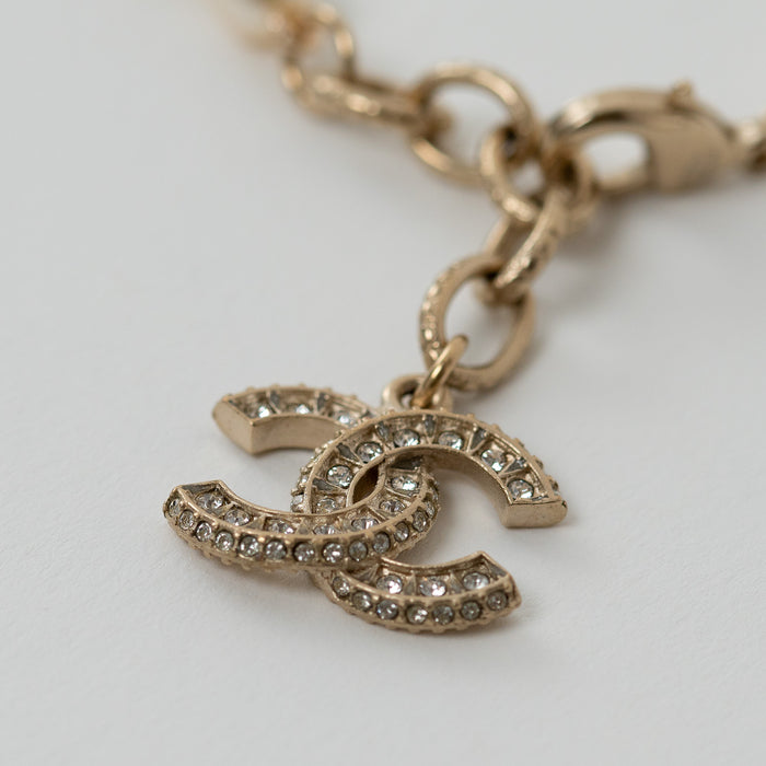 Pre-Loved Chanel™ Gold Tone and Faux Pearl Bracelet with Crystal Embellished Gold Logo