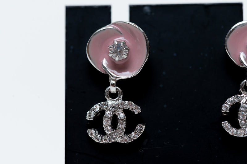 pink enamel camellia earrings with logo drop (close up)