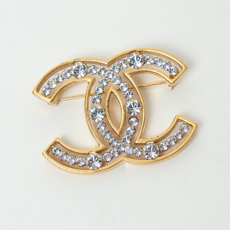 Pre-Loved Chanel™ Gold Tone Crystal Embellished Cut Out Logo Brooch