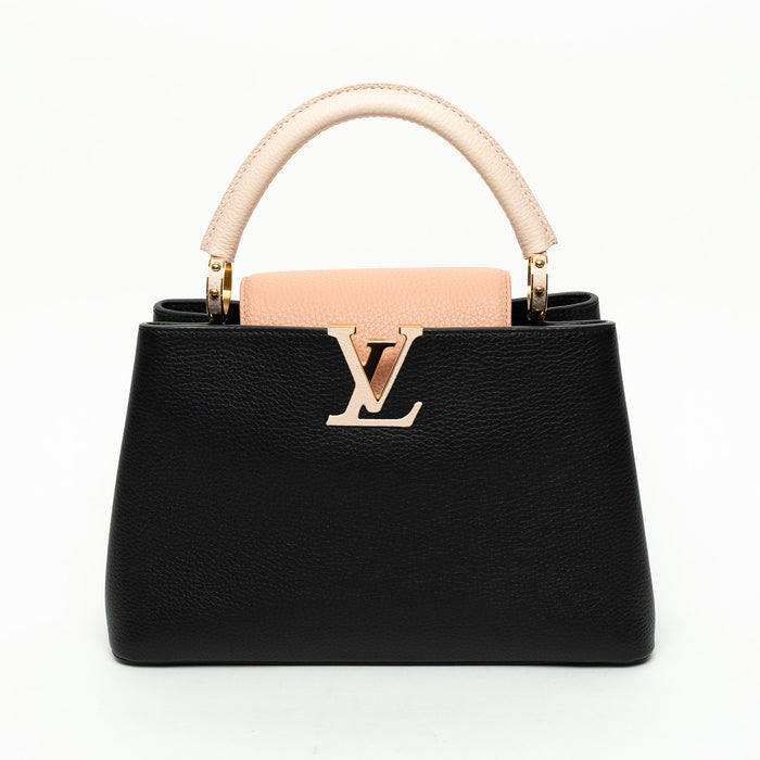 Black handbag with pink handle and logo on a white background