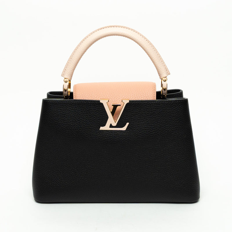 Black handbag with pink handle and logo on a white background