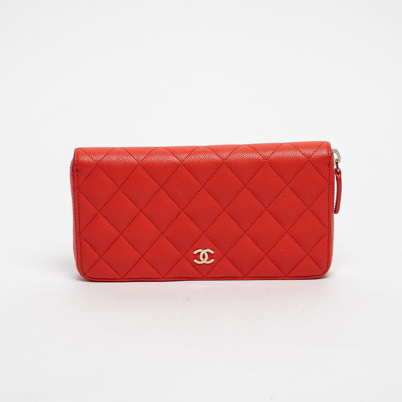 Red quilted handbag with gold CC logo on a white background