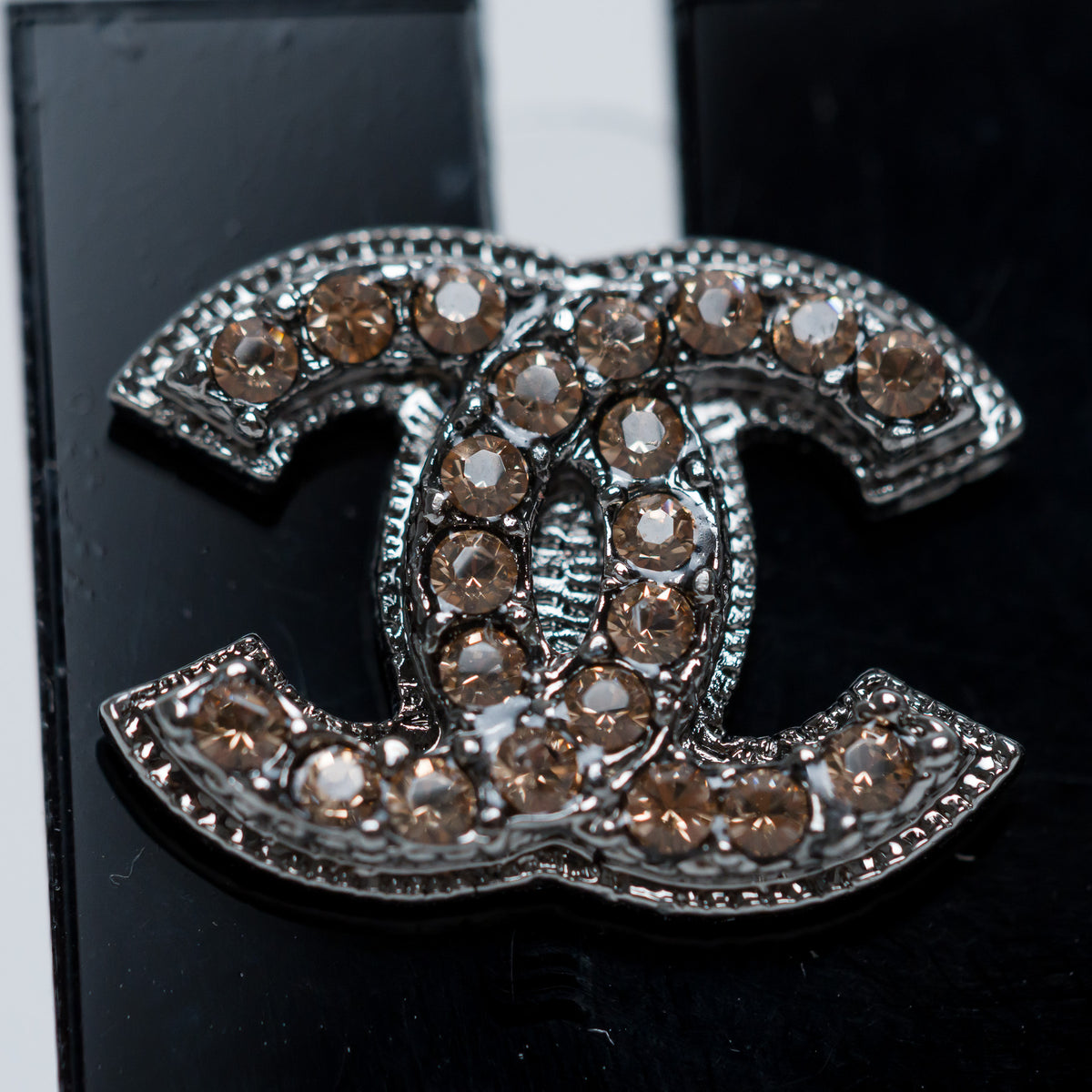 Pre-Loved Chanel™ Gunmetal Amber Crystal Logo Stud Earrings