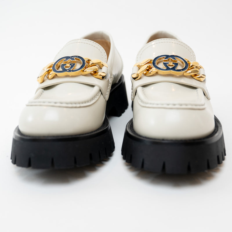 Close up front view of Gucci Gold Interlocking GG Chain White Leather Platform Loafers