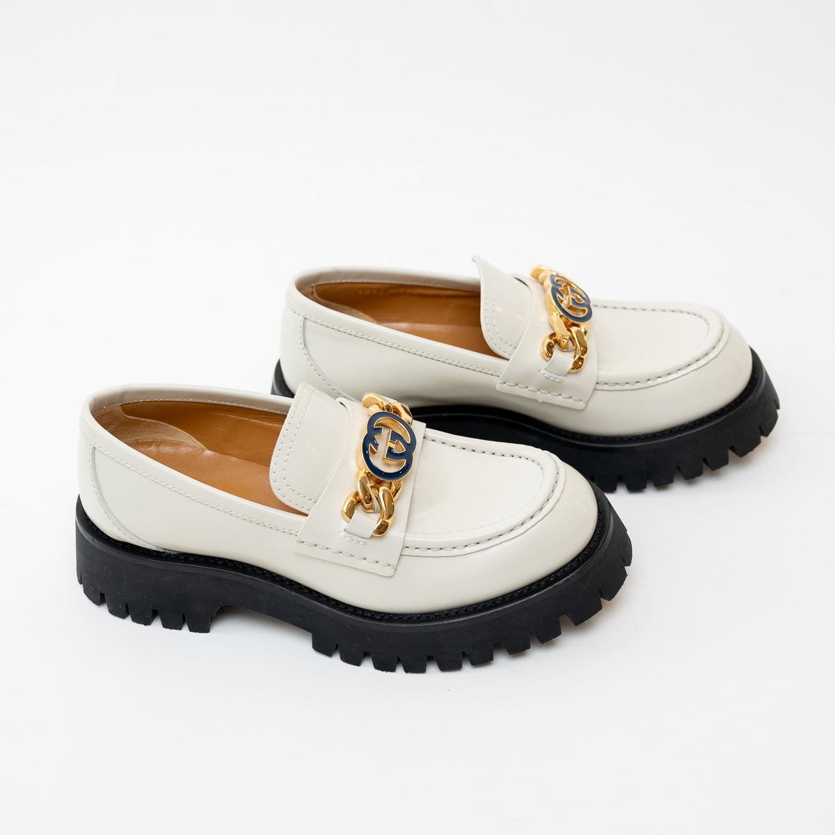 Side view of Gucci Gold Interlocking GG Chain White Leather Platform Loafers