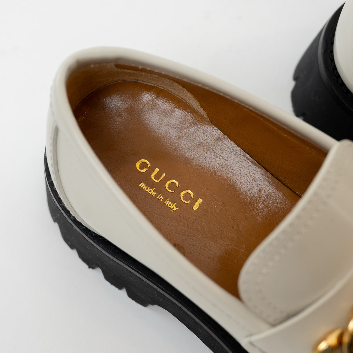 Insole close-up of Gucci Gold Interlocking GG Chain White Leather Platform Loafers