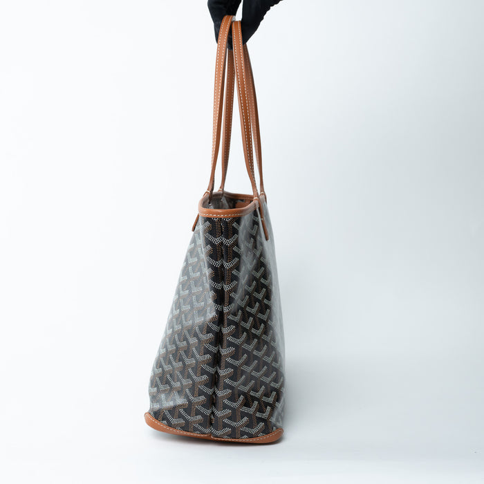 Handbag with a distinctive pattern held by a gloved hand on a white background