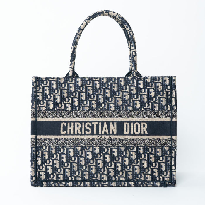 Christian Dior tote bag with monogram pattern on a white background