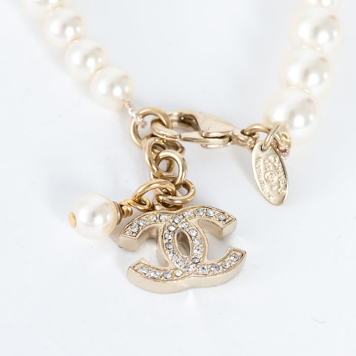 Pre-Loved Chanel™ Pearl Bracelet with Crystal Embellished Logo Pendant