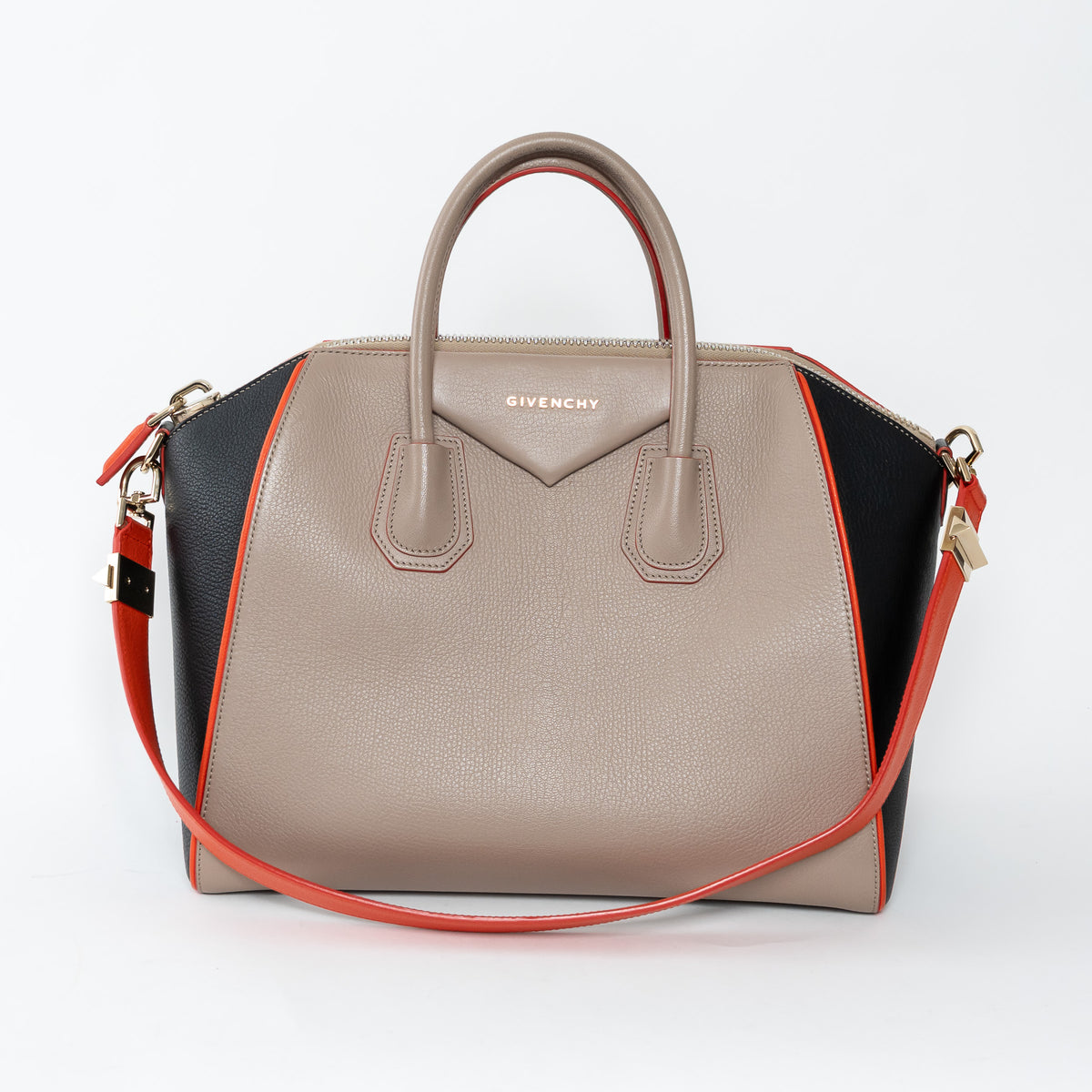 Givenchy handbag with beige, black, and orange design on a white background