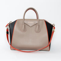 Givenchy handbag with beige, black, and orange design on a white background