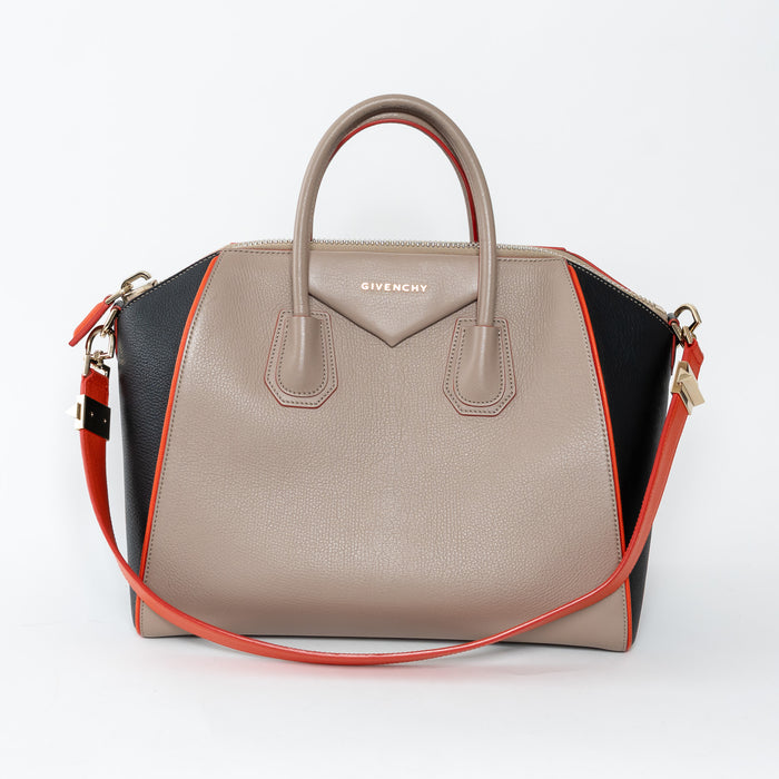 Givenchy handbag with beige, black, and orange design on a white background