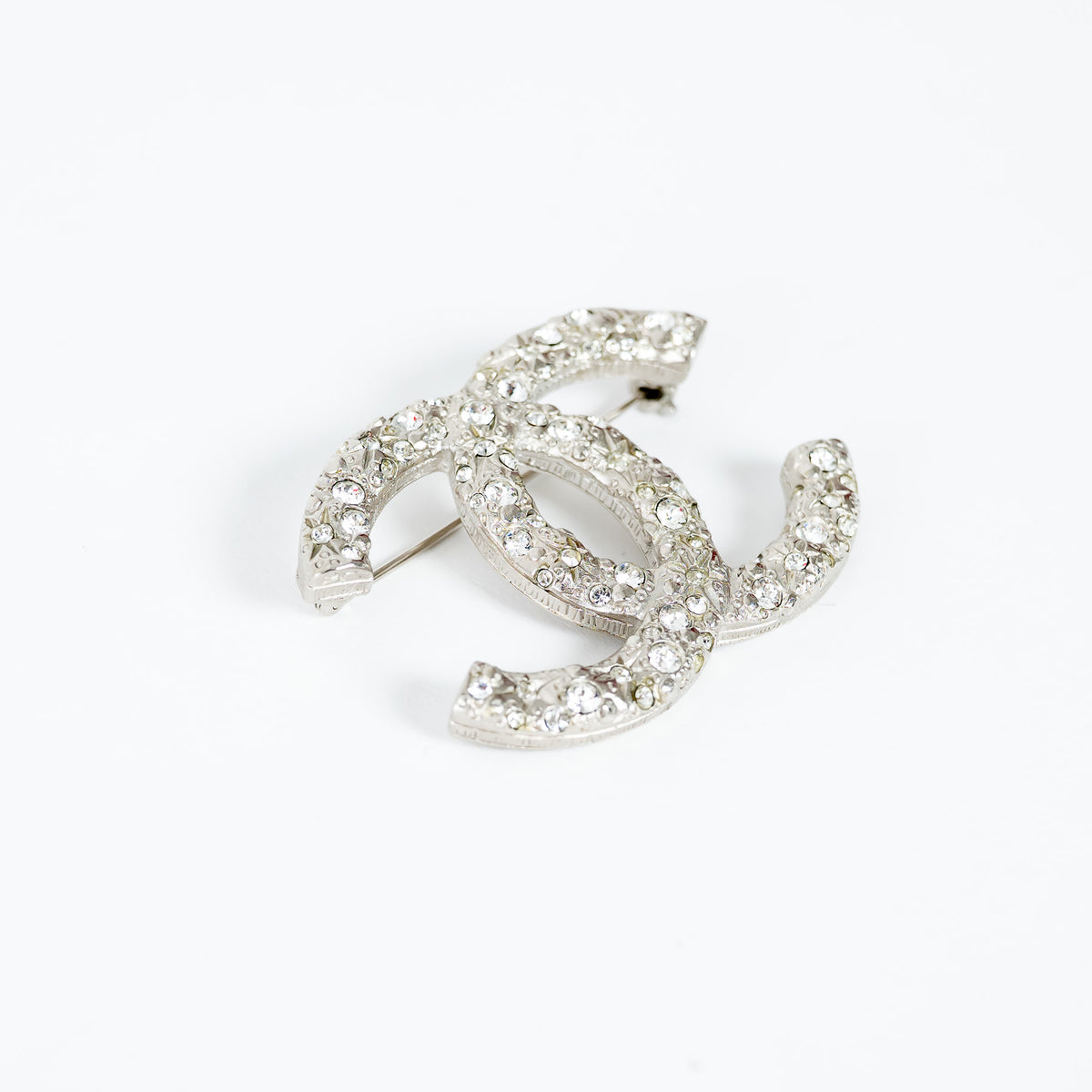 Pre-Loved Chanel™ Silver Tone Crystal Embellished Meteorite Interlocking Letter Brooch