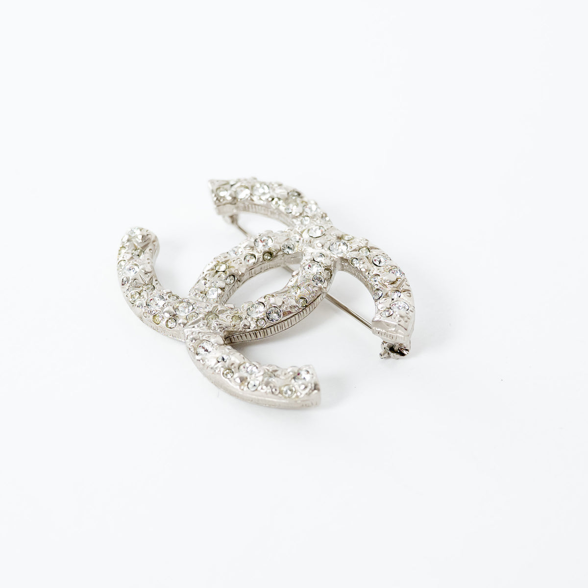 Pre-Loved Chanel™ Silver Tone Crystal Embellished Meteorite Interlocking Letter Brooch