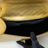 Pre-Loved Chanel™ Gold Patent Leather Medium Boy Bag