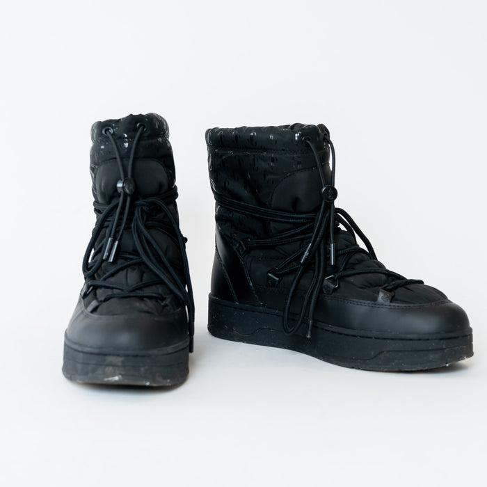 Pair of black high-top boots on a white background