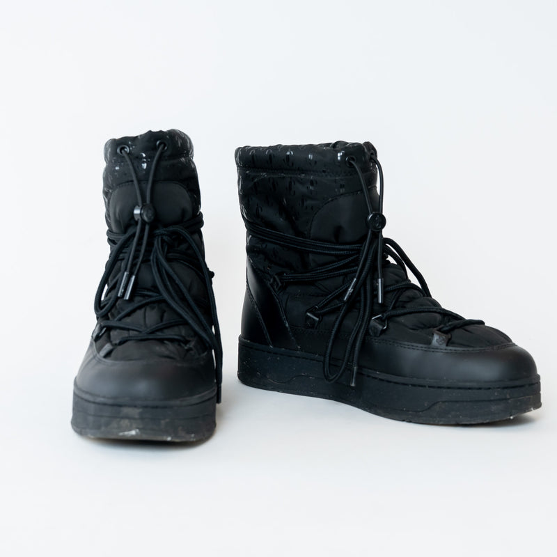 Pair of black high-top boots on a white background