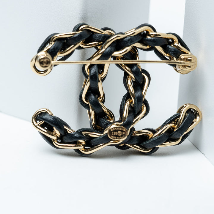 Black and Gold-Tone Leather Logo Brooch. (view 2)