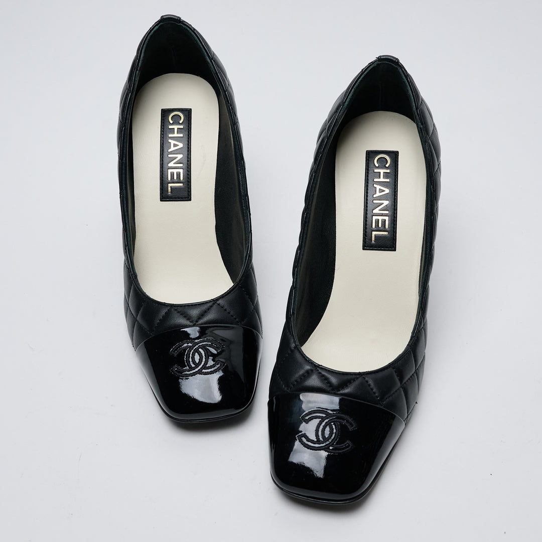 Black Quilted Lambskin Leather Cap Toe Pumps. (front)