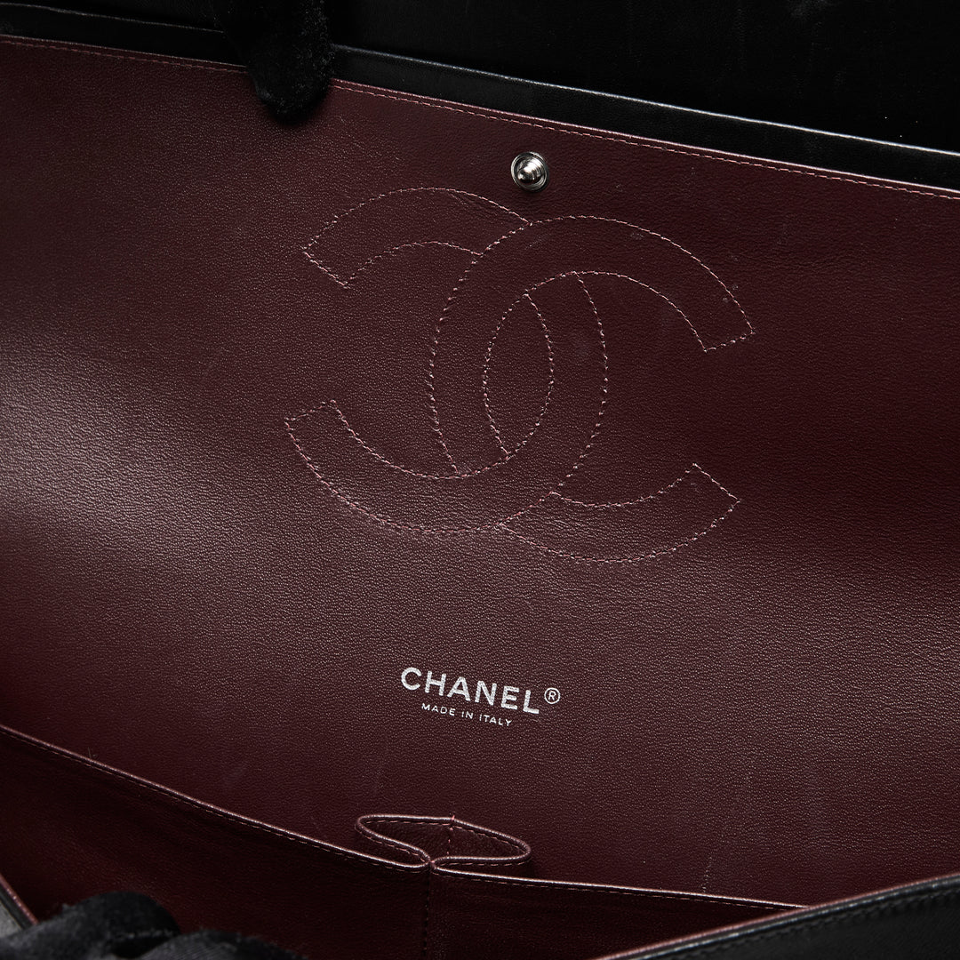 Pre-Loved Chanel™ Black Quilted Lambskin Leather Maxi Classic Double Flap Bag