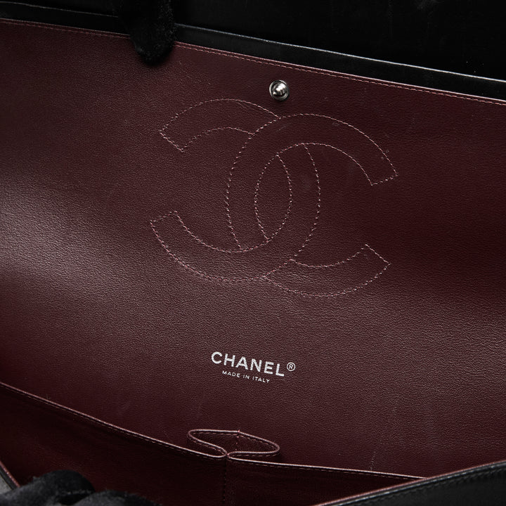Pre-Loved Chanel™ Black Quilted Lambskin Leather Maxi Classic Double Flap Bag