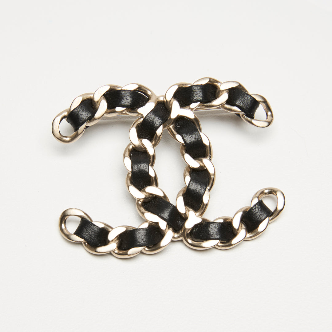 Pre-Loved Chanel™ Gold-Tone Interlaced Black Calf Leather Logo Brooch