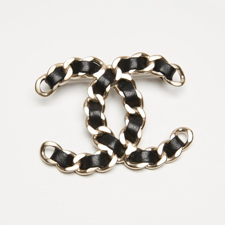 Pre-Loved Chanel™ Gold-Tone Interlaced Black Calf Leather Logo Brooch
