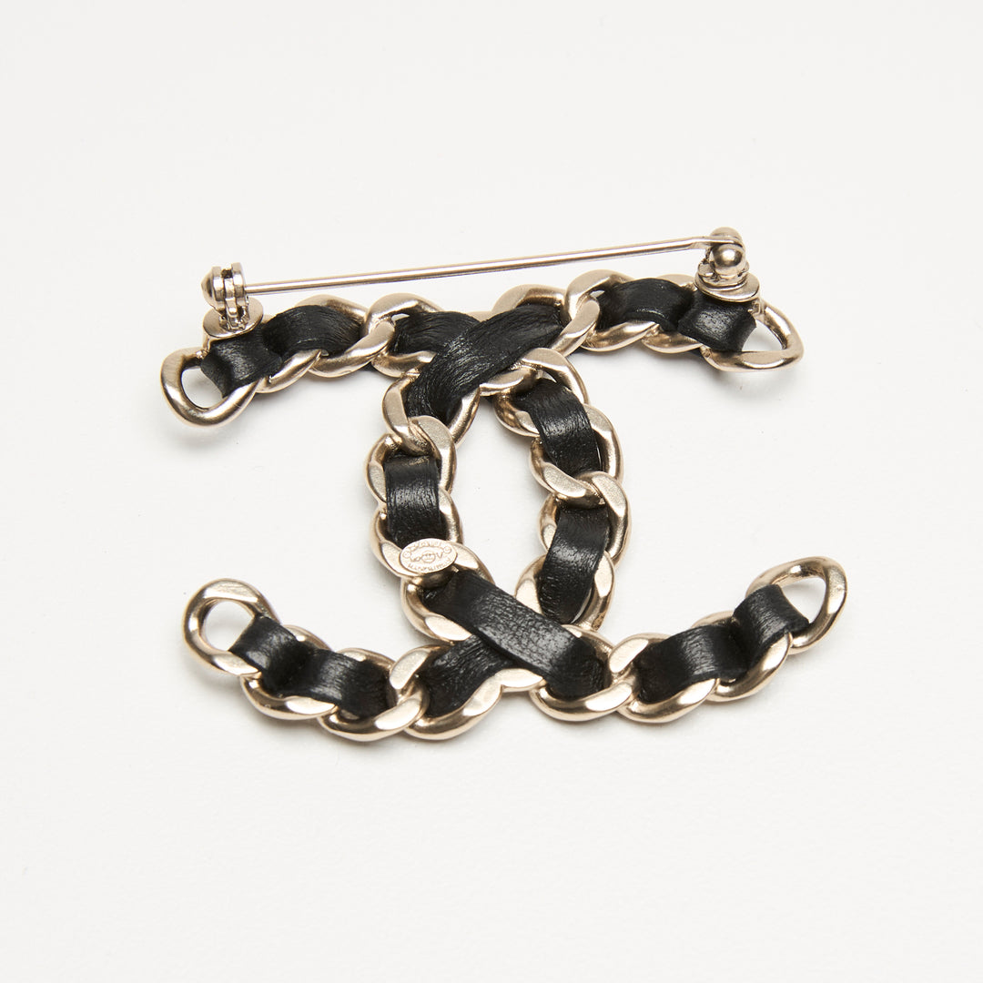 Pre-Loved Chanel™ Gold-Tone Interlaced Black Calf Leather Logo Brooch