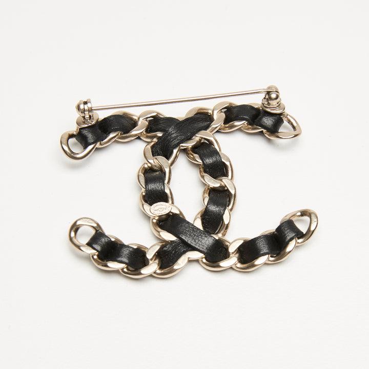 Pre-Loved Chanel™ Gold-Tone Interlaced Black Calf Leather Logo Brooch